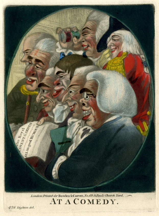 Eine Gruppe von Menschen, die in einem Kreis stehen, einer hält ein Blatt Papier in der Hand und lacht und amüsiert sich auf einer Comedy-Veranstaltung.